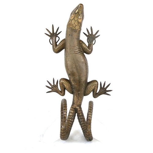 626 - A 19th century brass double coat hook in the form of a lizard climbing a wall, 27cms (10.5ins) high.