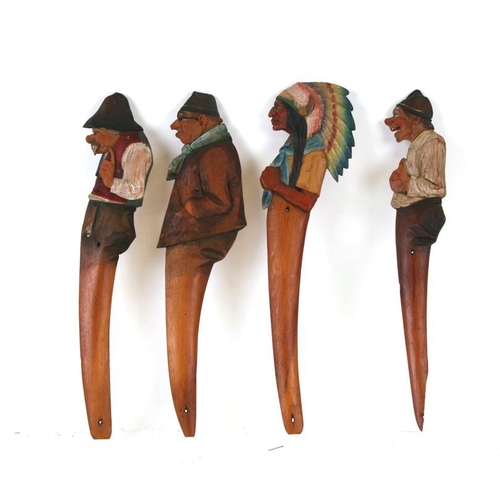 631 - A group four Anri figural letter openers to include a red Indian chief, the largest 33cms (13ins) hi... 