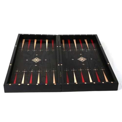 650 - An ebony and ivory folding backgammon/ chess board. 46cm (18ins) wide