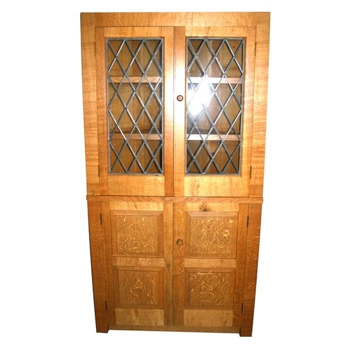 781 - A Monk Man Arts & Crafts style oak free-standing corner cupboard with a pair of astragal glazed ... 