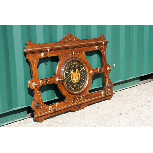 795 - A late Victorian / early Edwardian mahogany hanging coat rack, later decorated with a central rounde... 