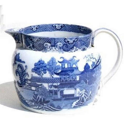 814 - An oversized  willow pattern jug. 17cm (6.75 ins) high