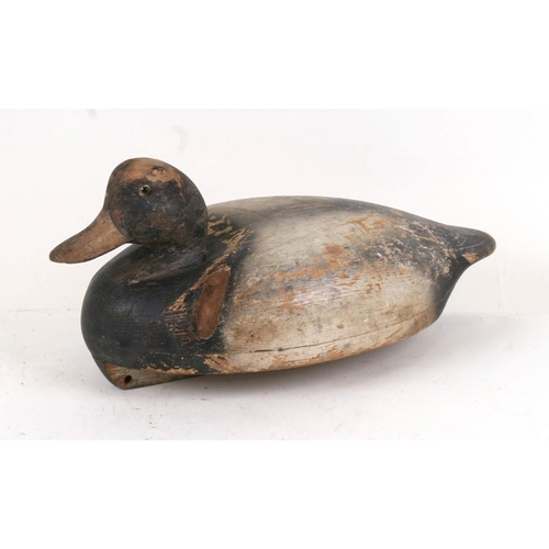 86 - A wooden and painted decoy duck, 26cms (10ins) wide.