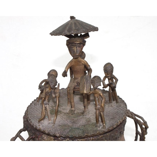 888 - An African tribal bronze urn and cover surmounted with figures, 27cms 910.5ins) high.