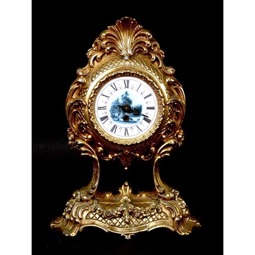 914 - An early 20th century gilt metal Continental mantel clock in the Rococo style, the enamel dial with ... 