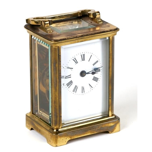 916 - A carriage clock with white porcelain dial with Roman numerals, in a four pillar brass case, 7.75cms... 