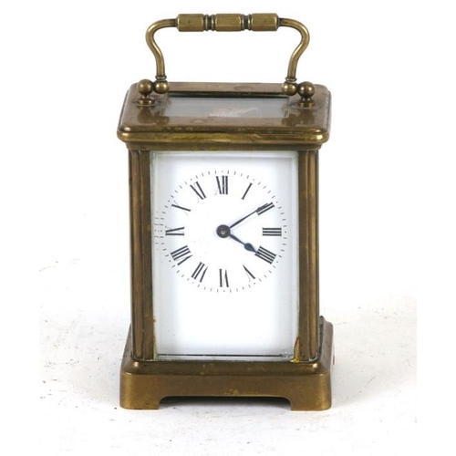 918 - A brass cased carriage clock, the white enamel dial with Roman numerals, 12cms (4.75ins) high.