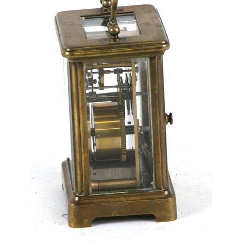 918 - A brass cased carriage clock, the white enamel dial with Roman numerals, 12cms (4.75ins) high.