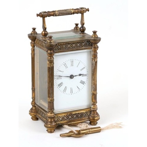 919 - An ornate Edwardian brass cased carriage clock, the white enamel dial with Roman numerals. 13cm (5 i... 