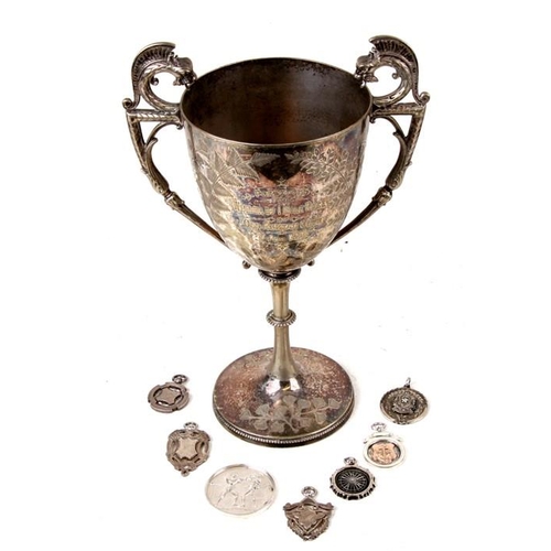 924 - A Victorian silver plated trophy; together with a quantity of silver fobs and medallions.