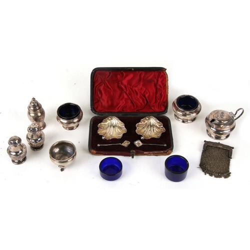 945 - A pair of silver shell shaped salts, boxed; together with a pair of silver peppers and other silver ... 