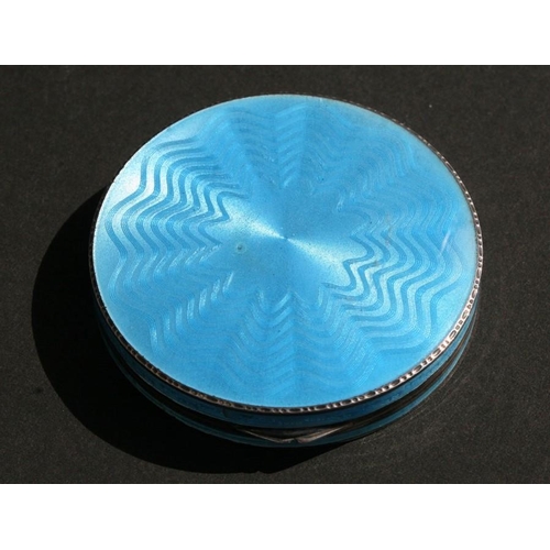 957 - A blue guilloche enamel powder compact with London import marks, 6cms (2.25ins) diameter.