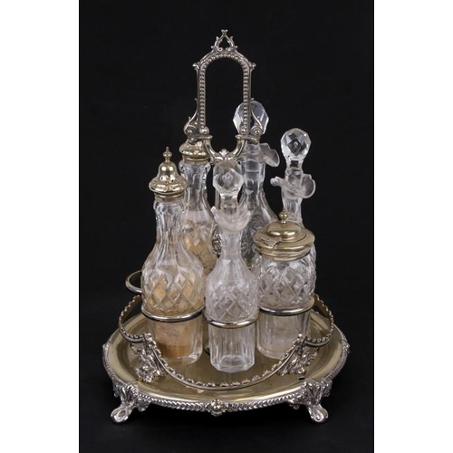 958 - An early 19th century seven bottle silver plated revolving condiment stand and six associated bottle... 