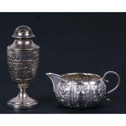 980 - A Victorian silver pepper caster, London 1889 together with a similar silver cream jug, London 1894.... 