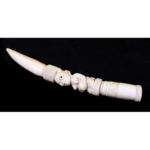 91A - An early 20th century African ivory tusk possibly Loango carved with a central kneeling figure hold ... 