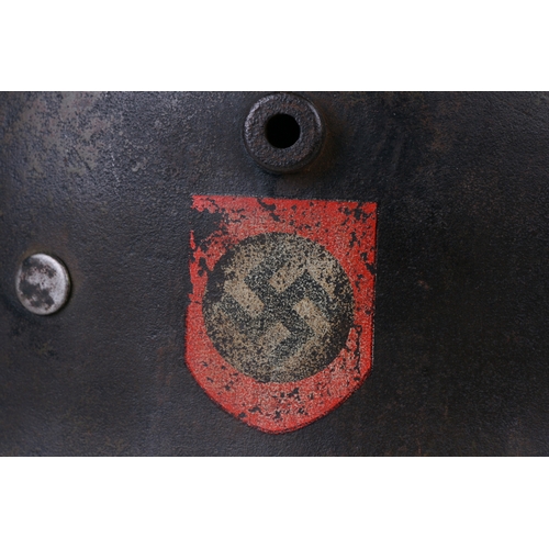 352 - A Third Reich M1916 double decal German helmet with traces of green camoflage paint, with liner and ... 