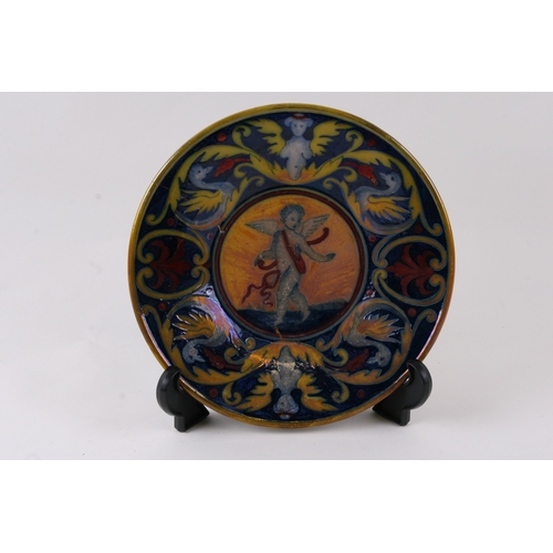 36 - A maiolica dish decorated with a central winged cherub, 23cms (9ins) diameter (a/f).