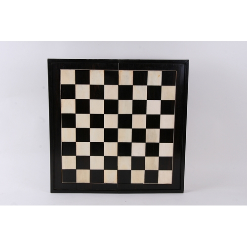 650 - An ebony and ivory folding backgammon/ chess board. 46cm (18ins) wide