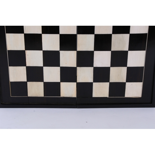 650 - An ebony and ivory folding backgammon/ chess board. 46cm (18ins) wide