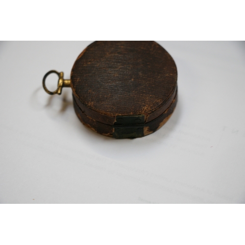 103 - A 19th century gilt metal pocket compass by Bate of London, cased, 4cms (1.5ins) diameter.