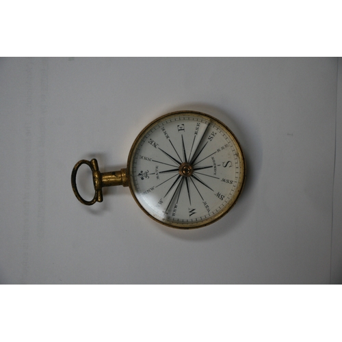 103 - A 19th century gilt metal pocket compass by Bate of London, cased, 4cms (1.5ins) diameter.