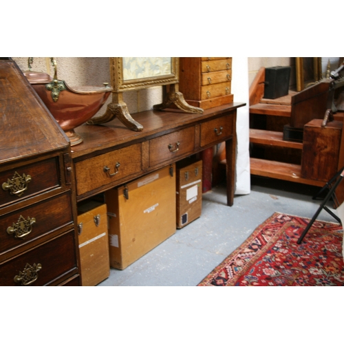 742 - An oak dresser base with three frieze drawers, on square tapering legs, 181cms (71.5ins) wide.