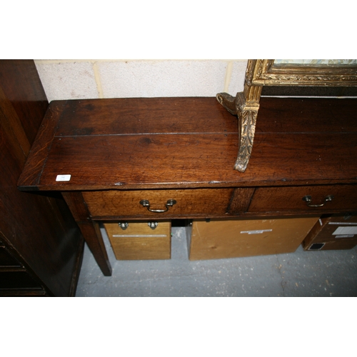 742 - An oak dresser base with three frieze drawers, on square tapering legs, 181cms (71.5ins) wide.