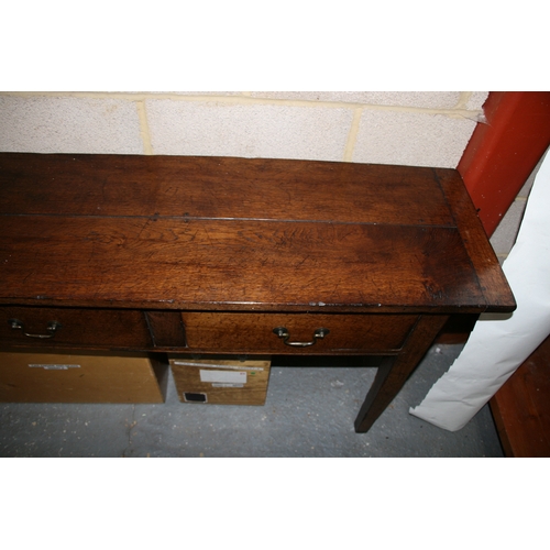 742 - An oak dresser base with three frieze drawers, on square tapering legs, 181cms (71.5ins) wide.