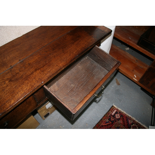 742 - An oak dresser base with three frieze drawers, on square tapering legs, 181cms (71.5ins) wide.