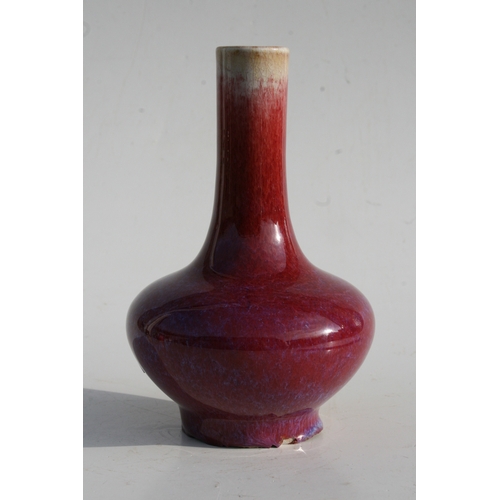 384 - A Chinese flambé vase with four character mark to the underside, 18cms (7ins) high.