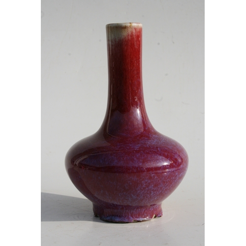 384 - A Chinese flambé vase with four character mark to the underside, 18cms (7ins) high.