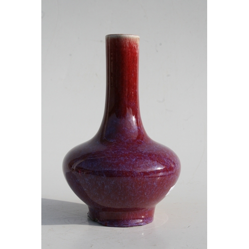 384 - A Chinese flambé vase with four character mark to the underside, 18cms (7ins) high.