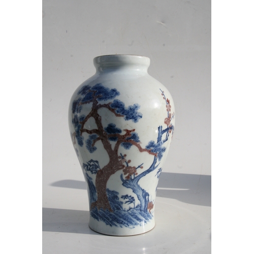 515 - A Chinese blue & copper red baluster vase decorated with a landscape scene, six character mark to th... 