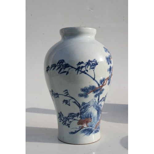 515 - A Chinese blue & copper red baluster vase decorated with a landscape scene, six character mark to th... 