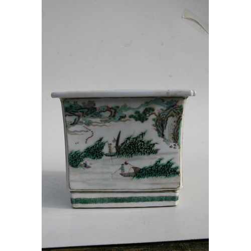 503 - A Chinese famille rose square form planter decorated with landscape scenes, 24cms (9.5ins) wide.