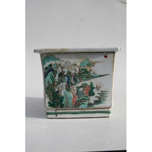 503 - A Chinese famille rose square form planter decorated with landscape scenes, 24cms (9.5ins) wide.