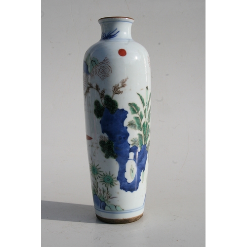 518 - A Chinese famille rose vase decorated with figures in a landscape, 25cms (9.75ins) high.