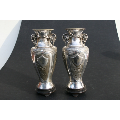 545 - A pair of Chinese silver plated vases of baluster form, embossed birds, bamboo, flowers and a vacant... 