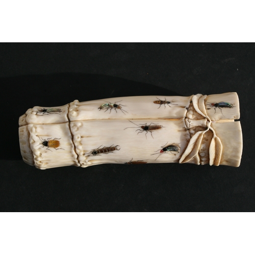 539 - An Oriental carved ivory wrist stand in the form of a bamboo section with shibayama insect decoratio... 