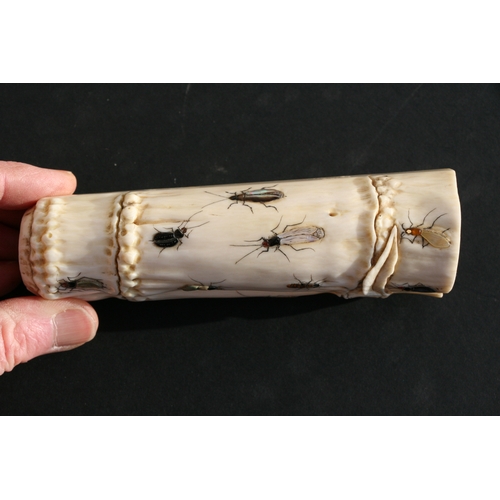 539 - An Oriental carved ivory wrist stand in the form of a bamboo section with shibayama insect decoratio... 