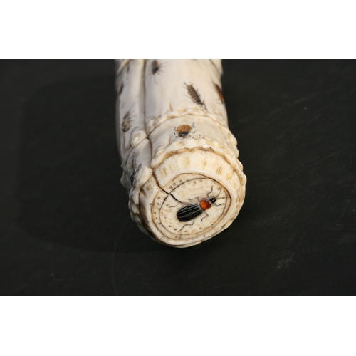 539 - An Oriental carved ivory wrist stand in the form of a bamboo section with shibayama insect decoratio... 