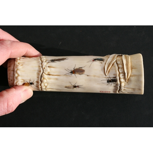 539 - An Oriental carved ivory wrist stand in the form of a bamboo section with shibayama insect decoratio... 