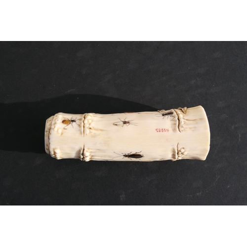 539 - An Oriental carved ivory wrist stand in the form of a bamboo section with shibayama insect decoratio... 