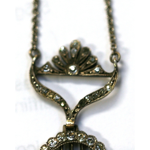 213 - An Edwardian silver necklace with paste set pendant.