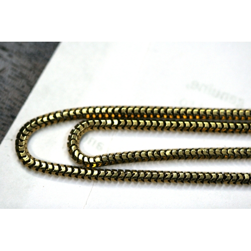 215 - A yellow metal (test as gold) snake skin link guard chain. Total length 168cm (66 ins).   36.8g