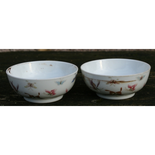 524 - A pair of Chinese porcelain wine cups decorated with butterflies, four character red mark to the und... 