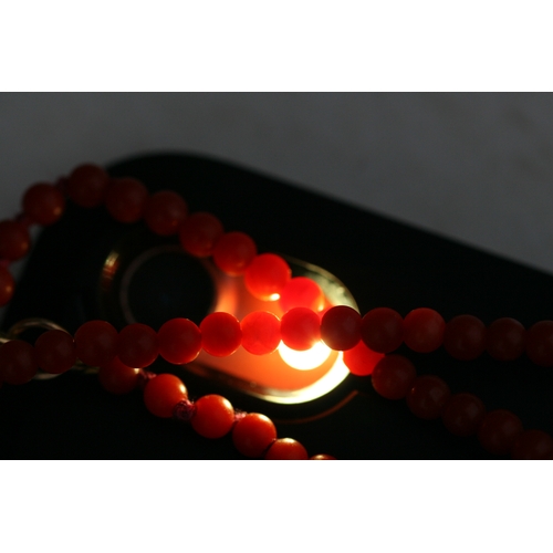 1014 - A coral bead necklace with 18ct gold clasp, 42cm (16.5 ins) long.