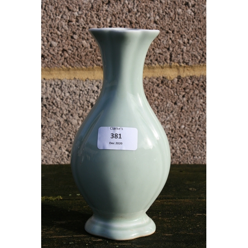 381 - A Chinese pale celadon glazed vase with blue seal mark to the underside, 20cms (8ins) high.