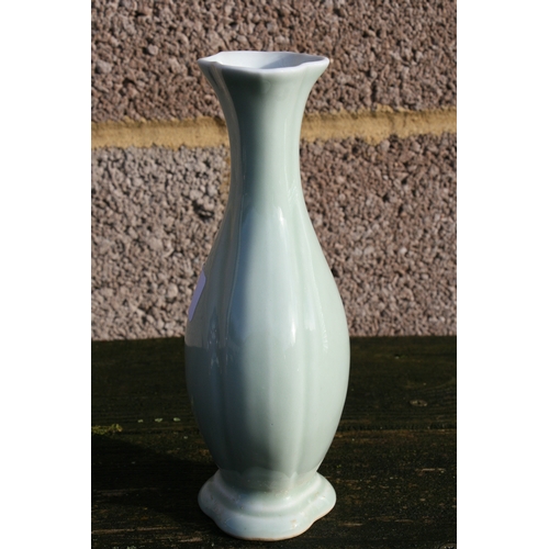 381 - A Chinese pale celadon glazed vase with blue seal mark to the underside, 20cms (8ins) high.