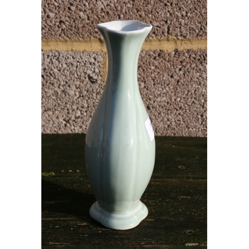 381 - A Chinese pale celadon glazed vase with blue seal mark to the underside, 20cms (8ins) high.